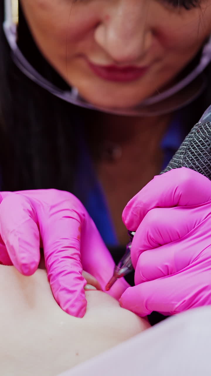 Woman in beauty salon. Beautician applies permanent ink on lips