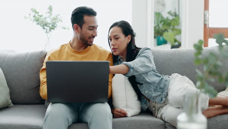 Couple,-laptop-and-laugh-on-sofa-in-home-for-love