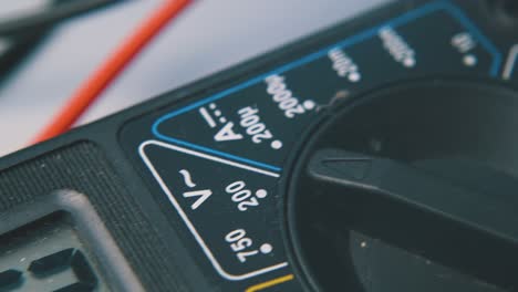 motion along multimeter with probes on white surface