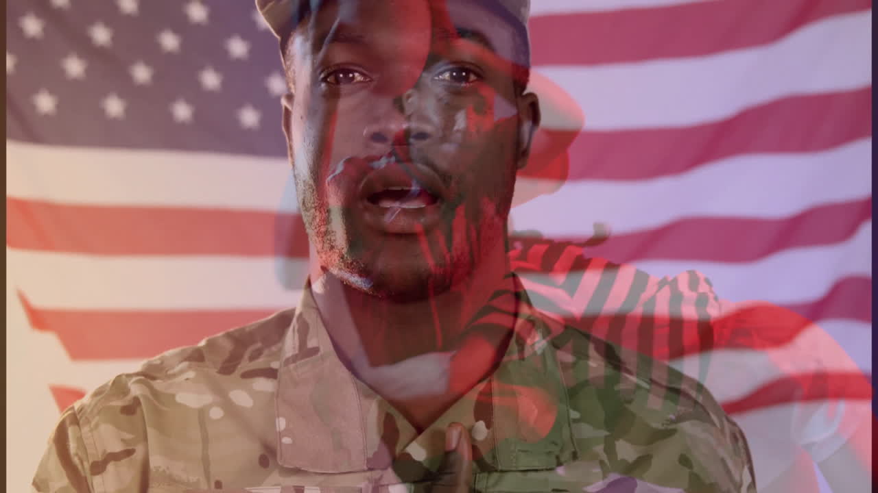 Soldier placing hand over heart during tech briefing, showing camouflage uniform with animated flag