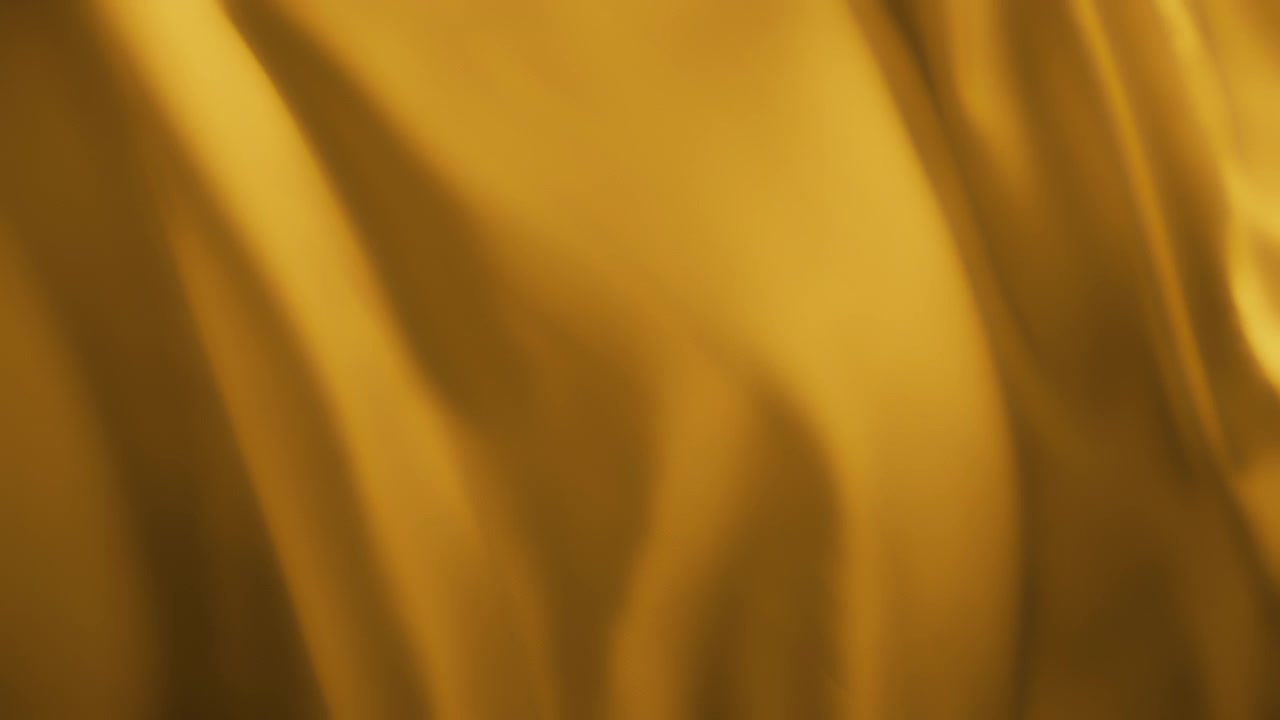 Wavy yellow chiffon fabric flowing in the wind. Abstract texture background