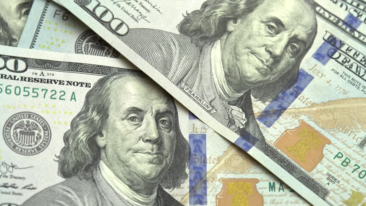 American dollars USD fall on the table, 100 US dollars counting. Concept use of money currency, financial markets