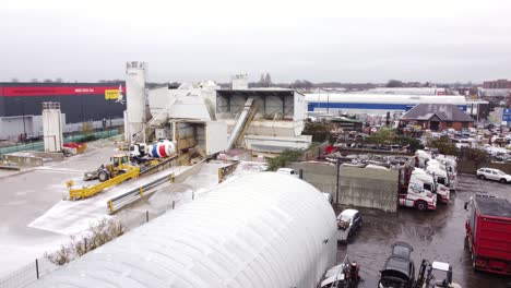 industrial cemex concrete manufacturing warehouse yard aerial view with trucks parked around machinery