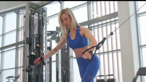 woman exercising on a cable machine at the gym