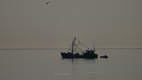 fishing boat silhouette at dawn/dusk
