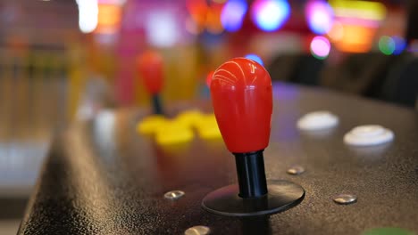 close-up of a red joystick on an arcade game