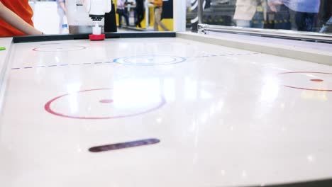 robot playing air hockey