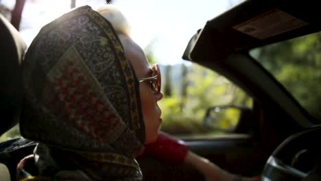 woman driving a convertible in sunny weather