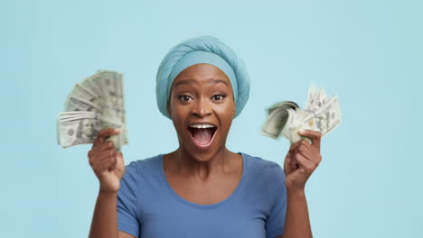 excited woman celebrating with money