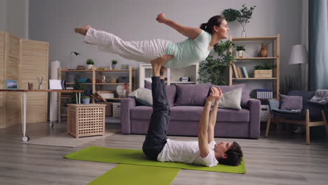 couple practicing acroyoga at home