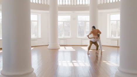 couple of male contemporary dancers dancing together in the studio