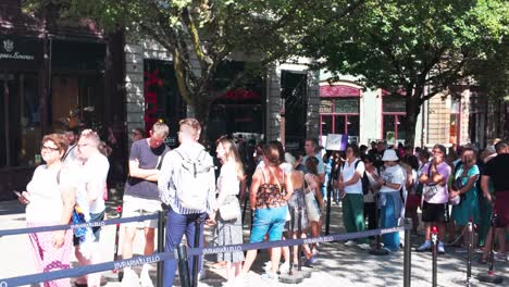 tourists walking toward the famous livraria lello bookstore in porto on a sunny day