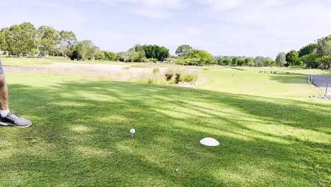 golfer tees off on sunny gold coast