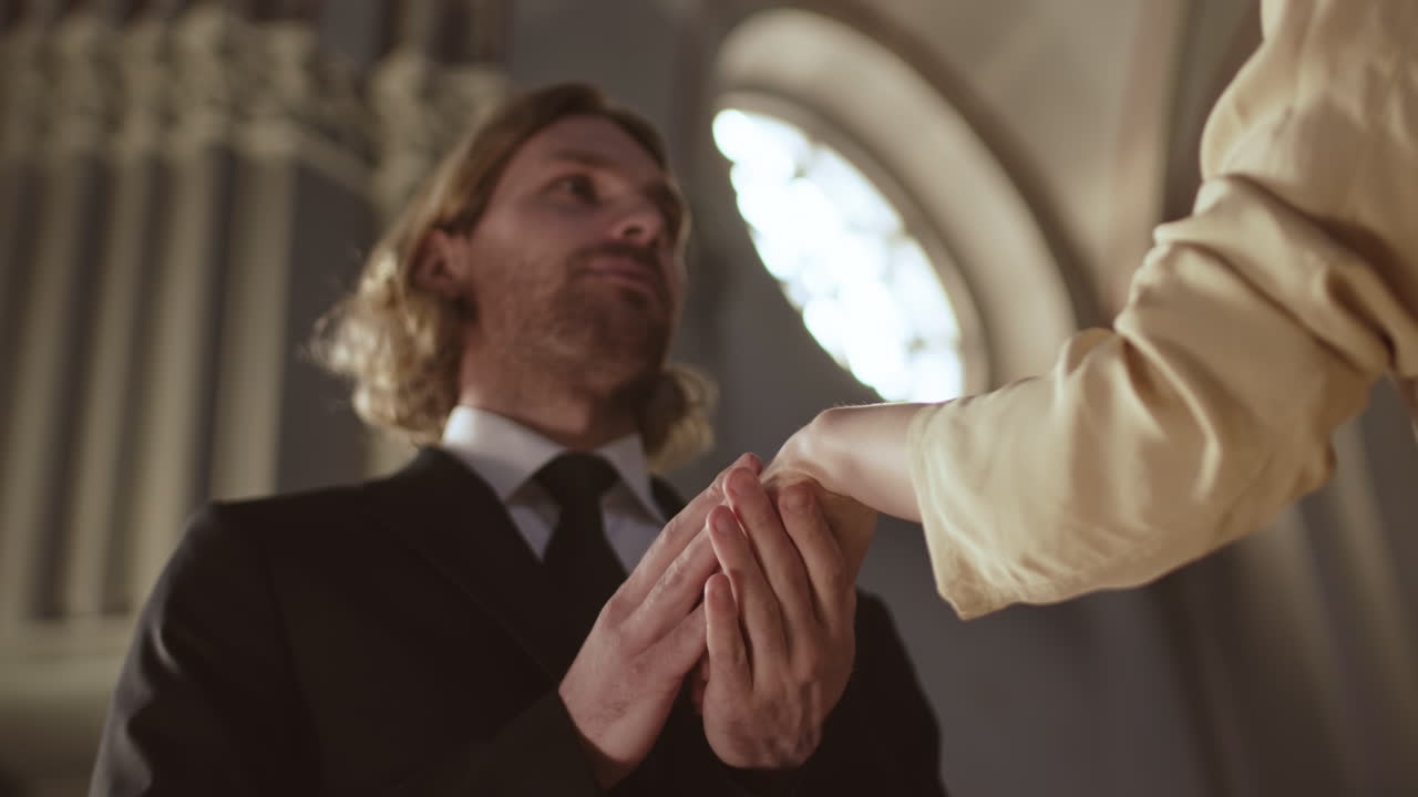 Groom Putting Ring on Bride during Wedding Ceremony