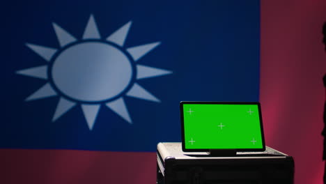 taiwanese freedom fighter walking in operation room in front of mockup tablet