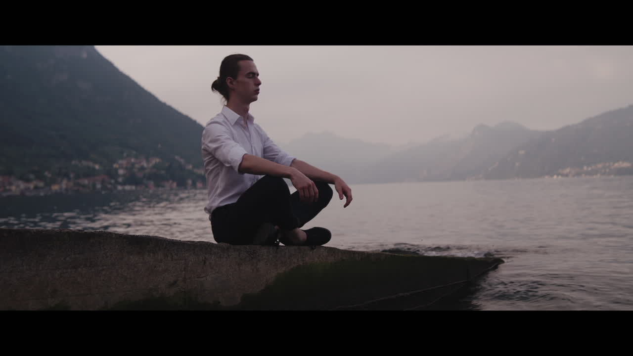 Man Meditating by a Lakeside