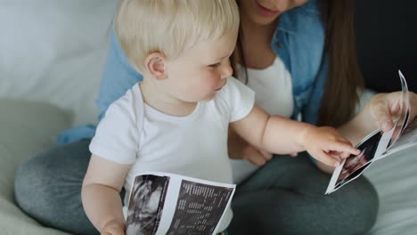 close up video of mother and son browsing ultrasound images.