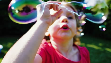 child playing with bubbles in a garden