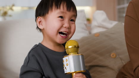 toddler singing with microphone
