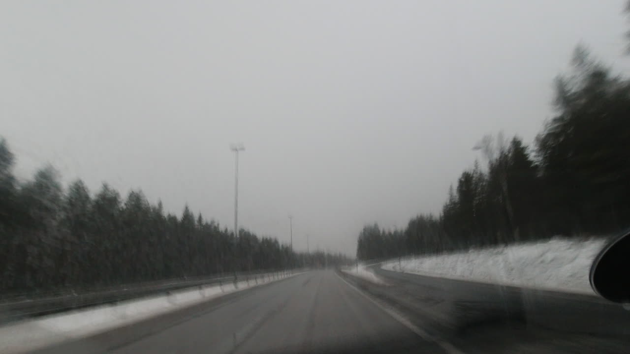 고속도로에서 운전할 때 물 스프레이와 자동차 와이퍼가 앞유리를 닦습니다.