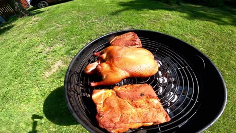 roast duck and pork on the grill on a summer day