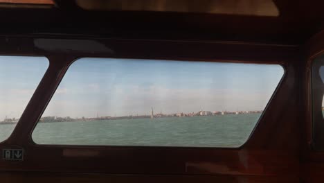 venezia city in horizon seen from inside of captains cabin in fast moving boat