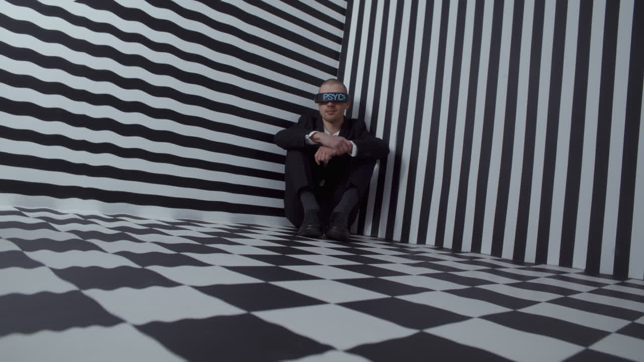 Man in a corner with eyes covered