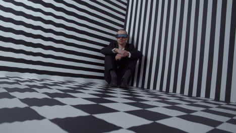 man in a corner with eyes covered
