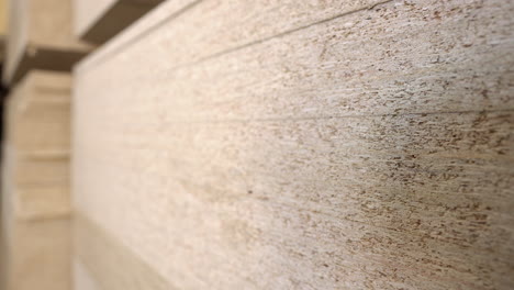 Stack-of-OSB-chipboard-on-pallet,-focus-pull-shot