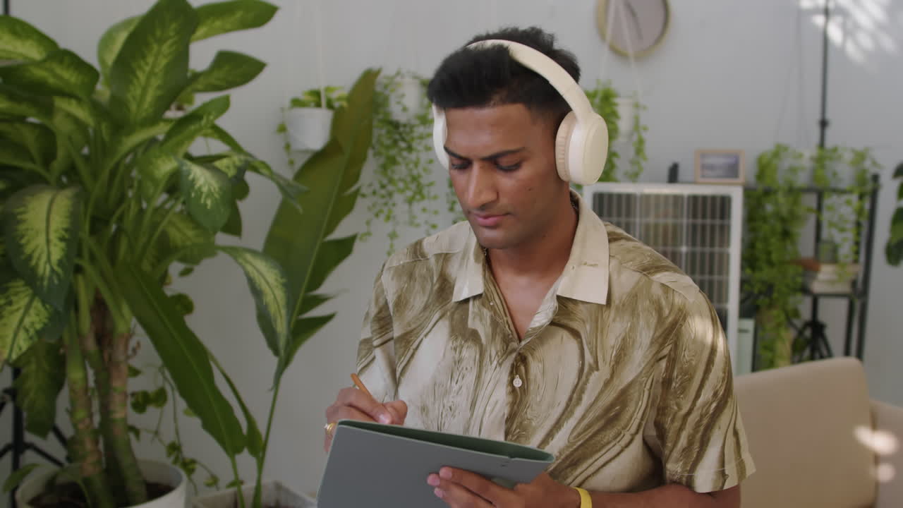 Creative Engineer Listening to Music when Working in Green Office
