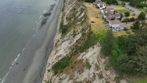 aerial shot tilting up to show the magnitude of the west beach bluff on whidbey island