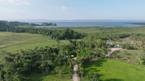 Luftüberflug-Wunderschöne-Grüne-Landschaft-Der-Dominikanischen-Republik-Mit-Dem-Karibischen-Meer-Im-Hintergrund-An-Sonnigen-Tagen