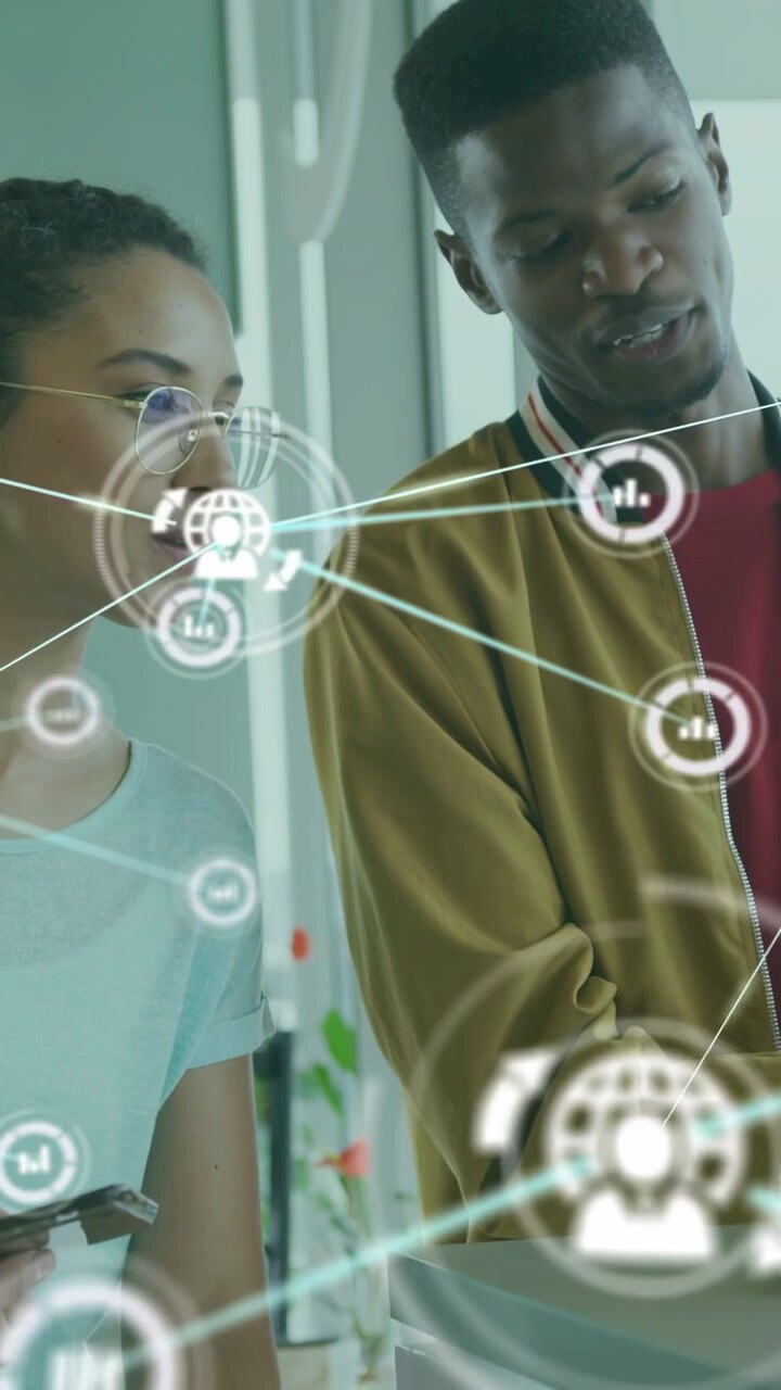 Vertical video: Woman tapping phone man pointing AR overlay growing with globe chart reviewing data