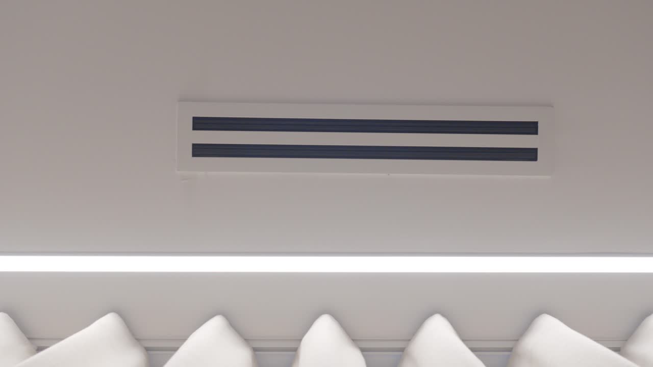 slow motion revealing shot of an air conditioning vents in a ceiling within a villa
