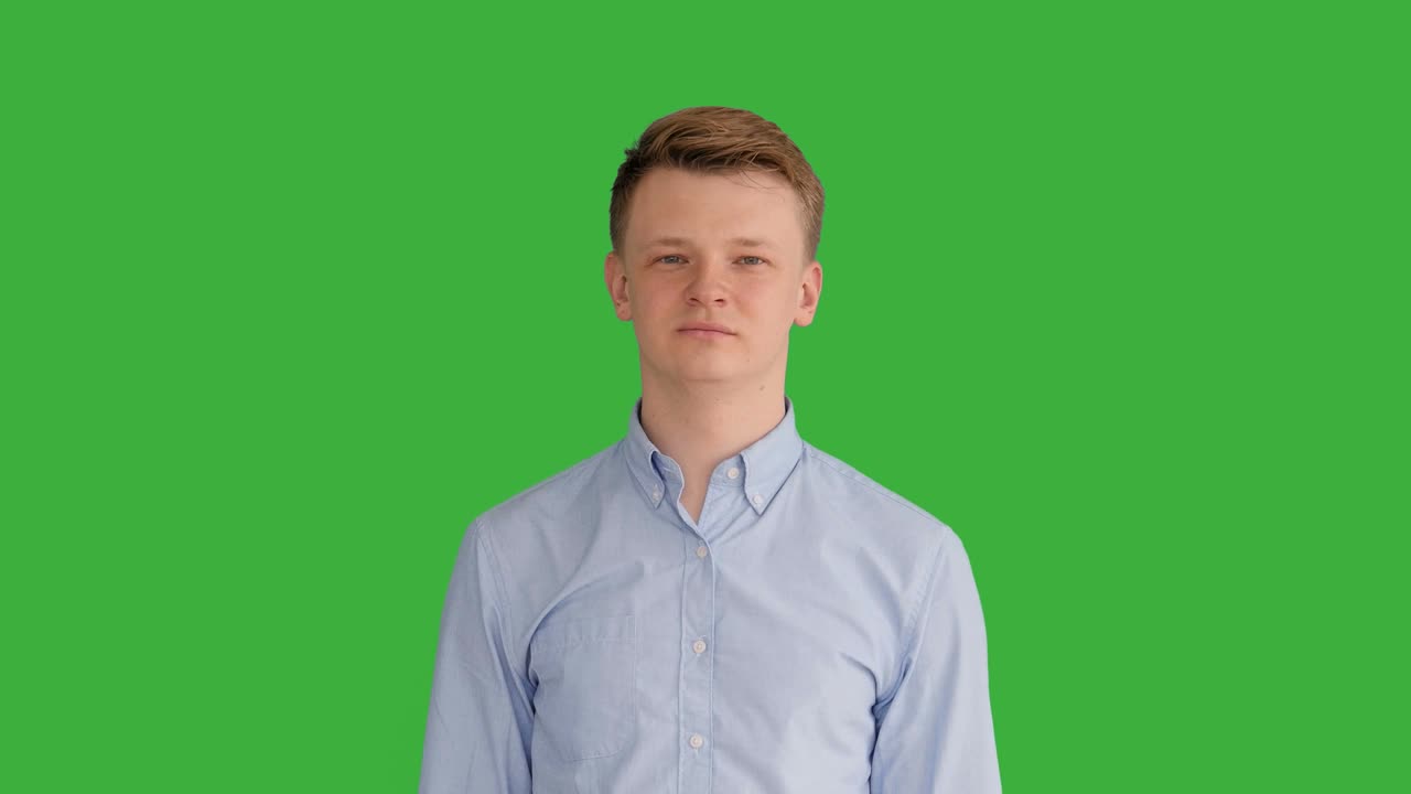 Young Caucasian Man Standing against Green Screen Background. Male Person Isolated on Chroma Key. Casual Business Professional Portrait