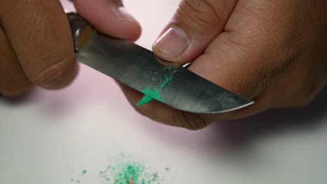 Footage-of-hands-slowly-sharpening-a-pencil-and-some-coloured-pencils-with-a-sharp-knife