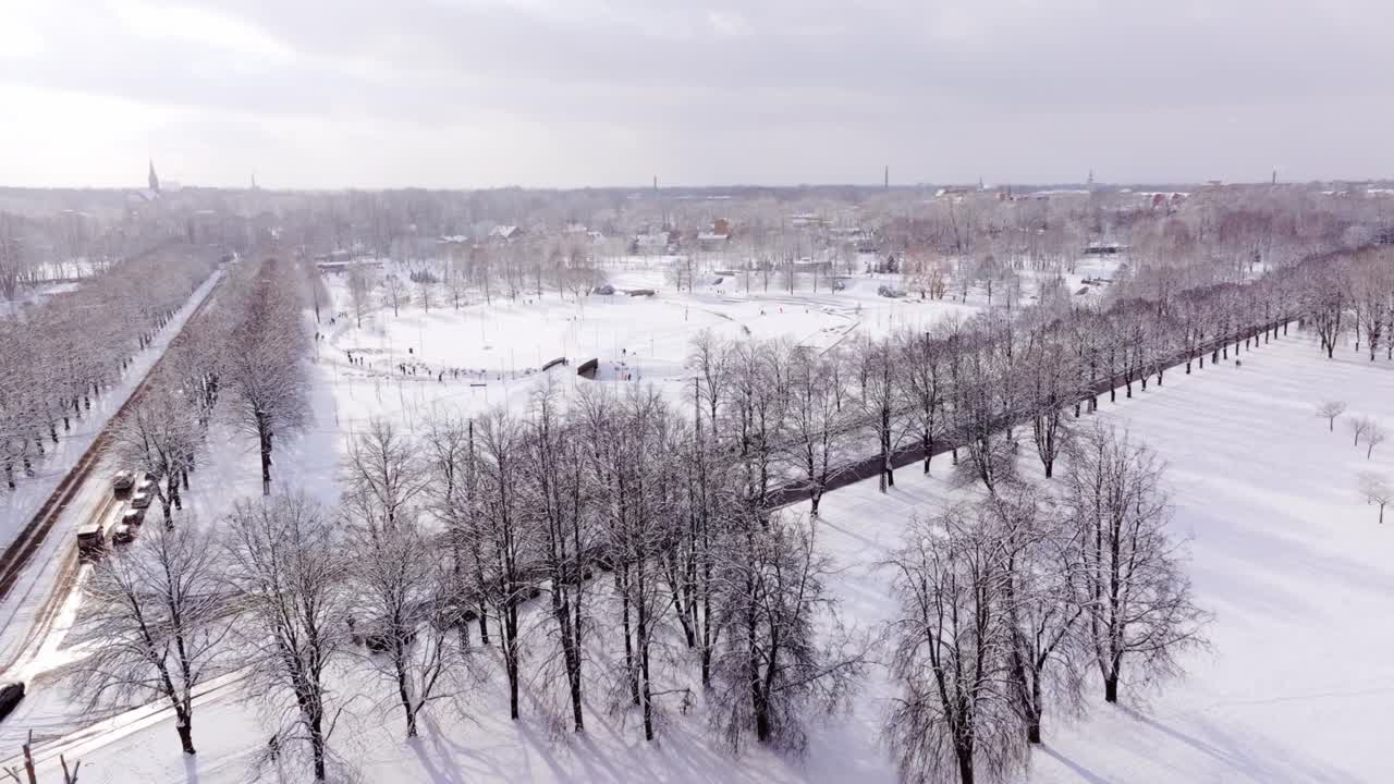 Drone Captures Fast Flyover Of Snowy Victory Park Latvia With Winter Activity