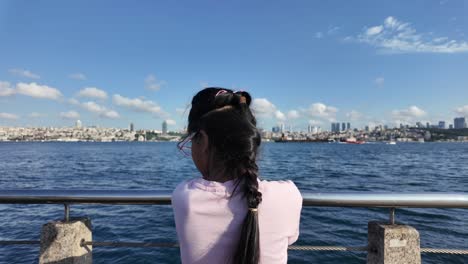 a person views the distant city skyline over the water