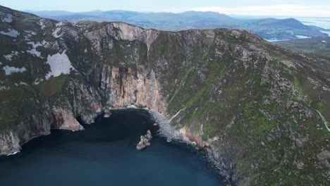 Drone-video-flying-towards-Slieve-League,-Ireland-at-sunset