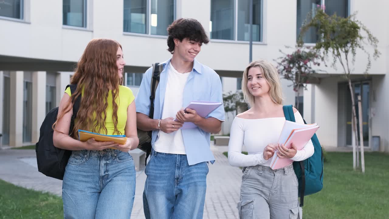 Happy university students with notebooks on campus