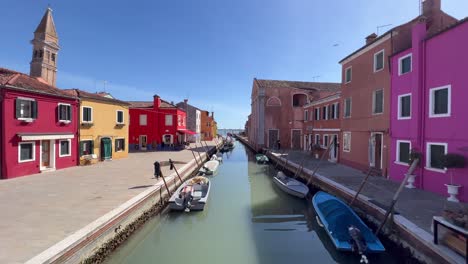 4k gimbal shot unveiling vibrant burano island, venice, italy: colorful houses, tranquil canals, historic ambience