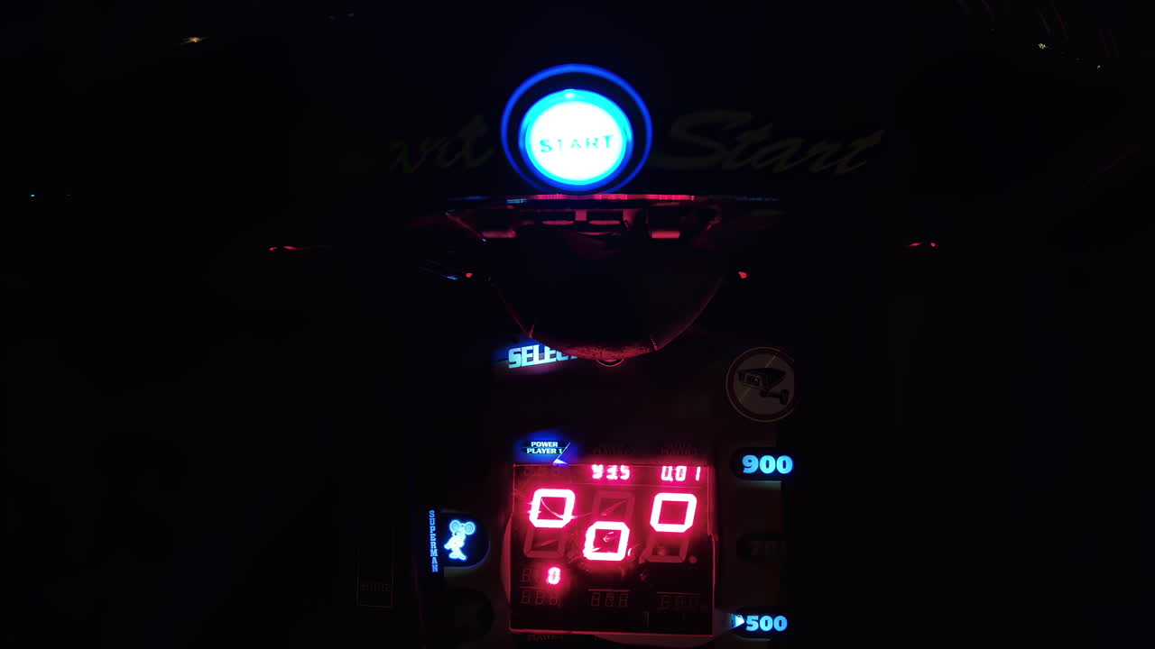 Bright lights and vivid displays take center stage as players engage in competitive arcade games in a lively entertainment center, creating an energetic atmosphere