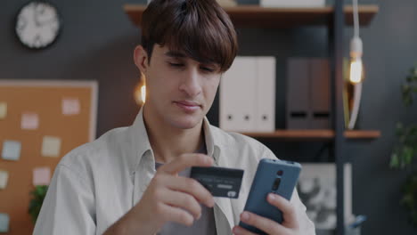 man making mobile payment with credit card