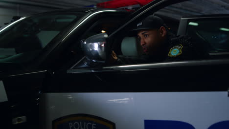 Police-team-standing-at-police-car.-Police-officers-aiming-guns-behind-vehicle