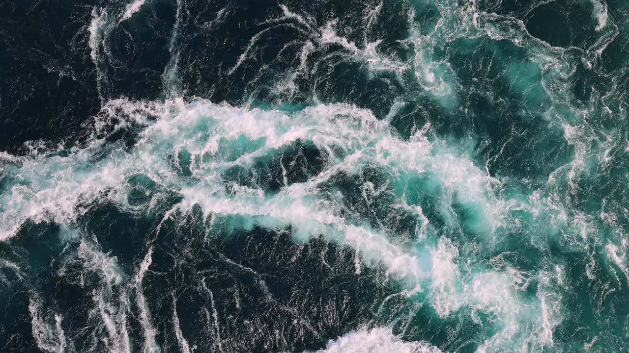 Blue waves of water of the river and the sea meet each other during high tide and low tide.