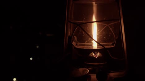 At-dark-night-campsite,-kerosene-oil-lamp-is-lit-with-burning-match