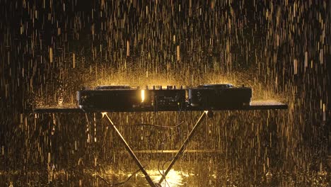 dj equipment under golden rain