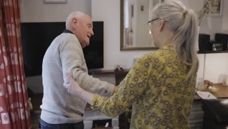 assisting senior man in home