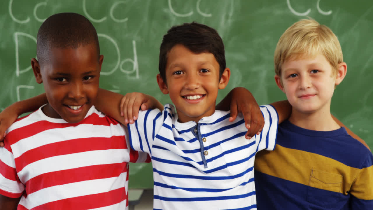 School kids standing together with arm around in classroom