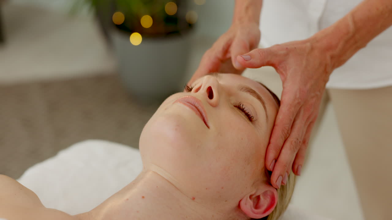 Spa, hands and head massage on bed for wellbeing
